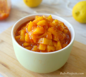 Sweet Lemon Pickle, Maharashtrian Recipe on a Green Bowl with Lemons in the Background